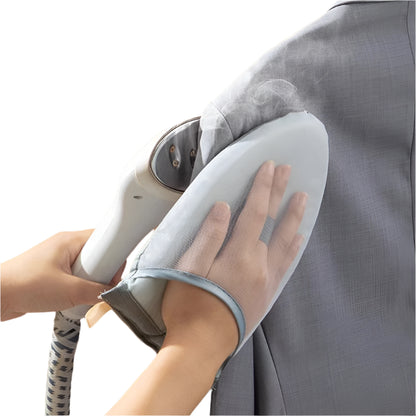 Person using a steam iron on a piece of fabric against an orange background