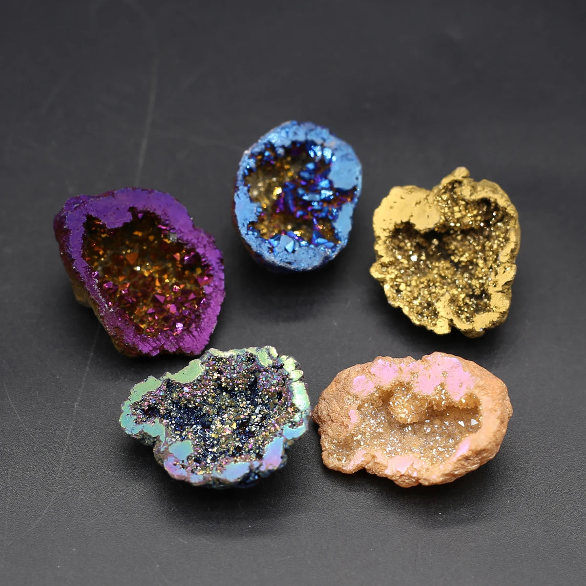 Five colorful geode-like rocks on a dark gray background