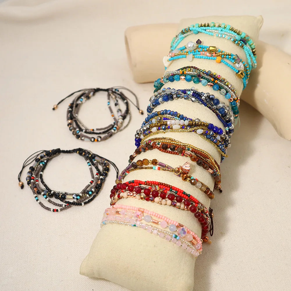 Collection of beaded bracelets on a beige surface