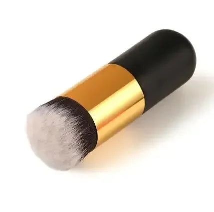 Makeup brush with black and gold handle on a white background