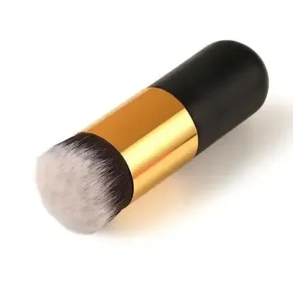Makeup brush with black and gold handle on a white background