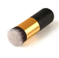 Makeup brush with black and gold handle on a white background