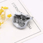 Geode crystal on a white surface with yellow flowers and text in the background