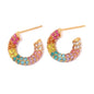Colorful hoop earrings with gemstones on a white background