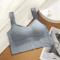 Light blue ribbed tank top on a textured surface with a magazine underneath