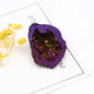 Purple geode crystal on a white surface with yellow flowers