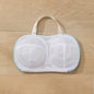 White mesh bra with a handle on a wooden surface