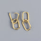 Pair of gold hoop earrings on a gray background