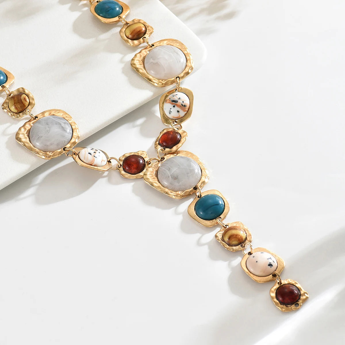 Necklace with multicolored gemstones on a white surface