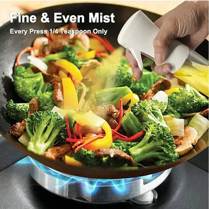 Sprinkling seasoning over stir-fry vegetables with a handheld seasoning device.