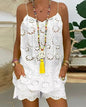 White lace dress worn by a person with a colorful necklace and bracelets.