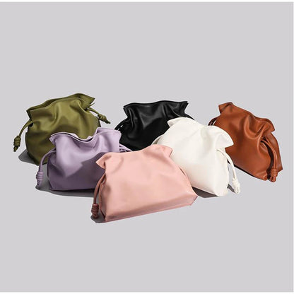 Set of six drawstring bags in various colors on a light gray background