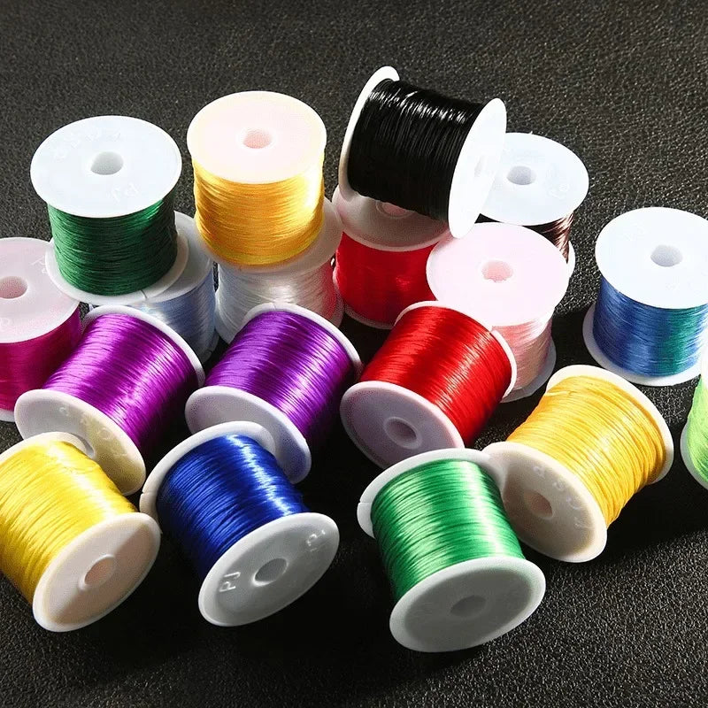 Assorted spools of thread in various colors on a dark surface