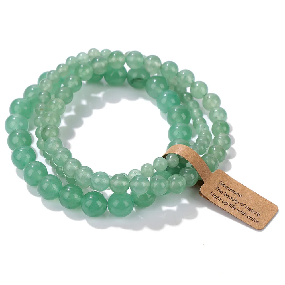 Green beaded bracelet with a wooden tag on a white background