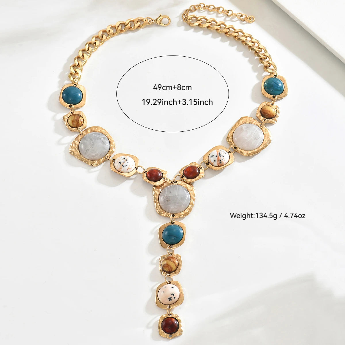 Gold necklace with colorful stones on a white background