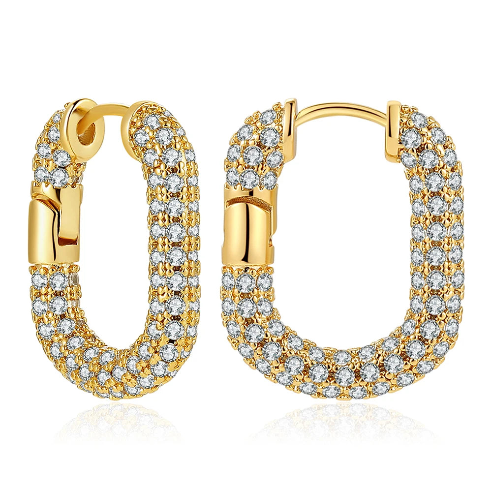 Gold hoop earrings with clear gemstones on a white background