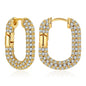 Gold hoop earrings with clear gemstones on a white background