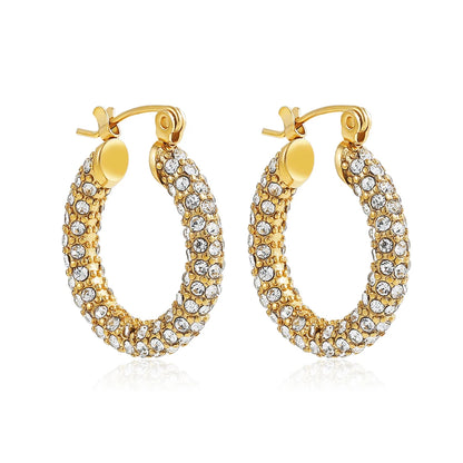 Gold hoop earrings with clear gemstones on a white background