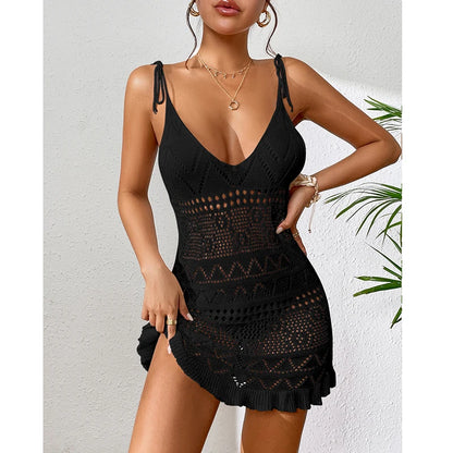 Woman wearing a black crochet dress against a white background