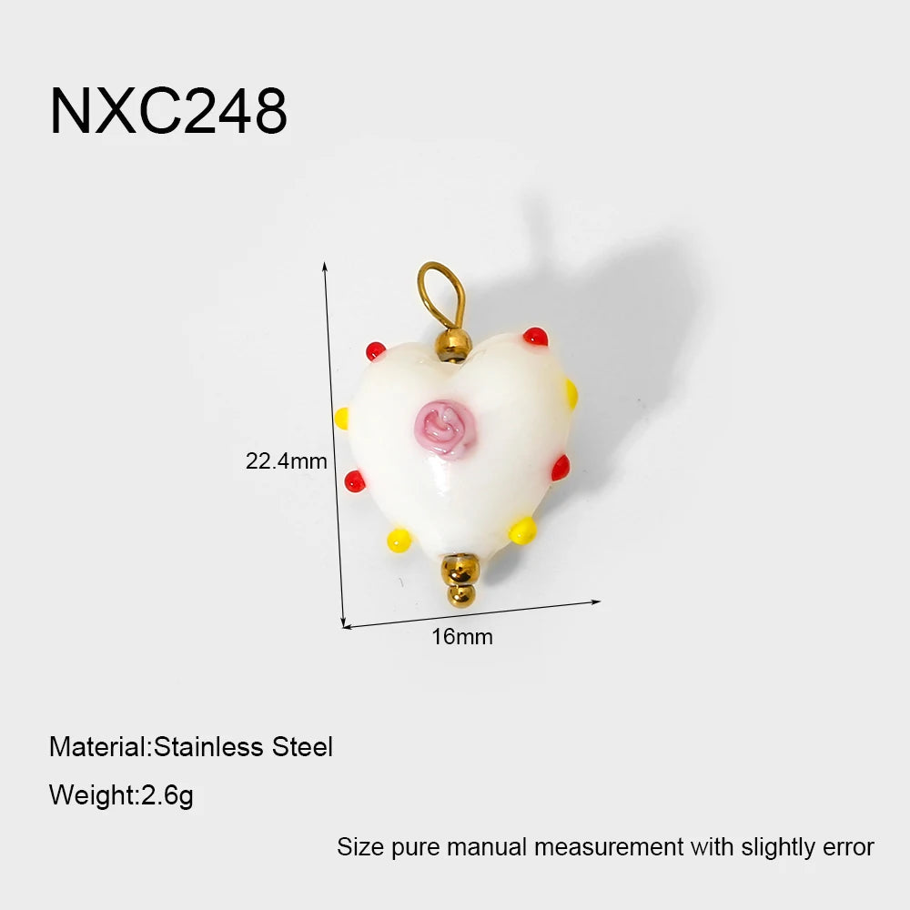 Heart-shaped pendant with measurements and material details on a white background