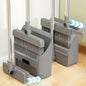 Gray broom and dustpan set on a wooden floor with a light background