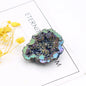 Multicolored geode crystal on a white surface with 'ETERNITY' text