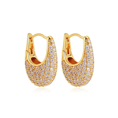 Gold hoop earrings with clear gemstones on a white background