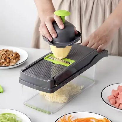 Person using a mandoline slicer to slice vegetables on a kitchen counter.