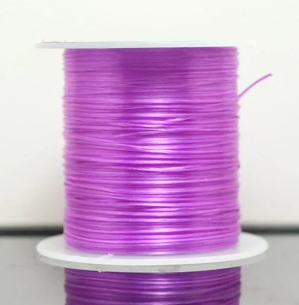 Spool of purple thread on a white background