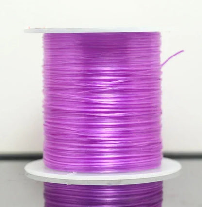 Spool of purple thread on a white background