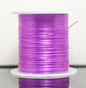 Spool of purple thread on a white background