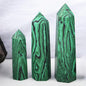 Three green crystal-like structures with black patterns on a white background