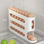White egg holder with eggs inside, showing dimensions on a refrigerator door.