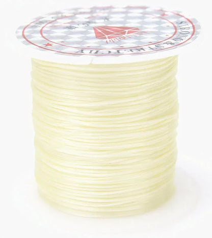Spool of cream-colored thread with a brand label on a white background