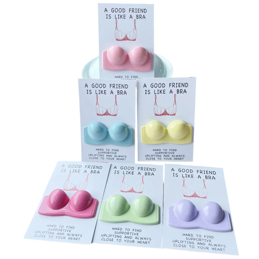 Set of colorful silicone bras with cards on a beige surface