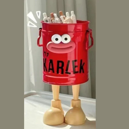 Red toy bucket with a face and legs, labeled 'Karlek', on a neutral background.