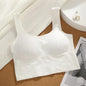 White bralette on a cork surface with a magazine and jewelry in the background