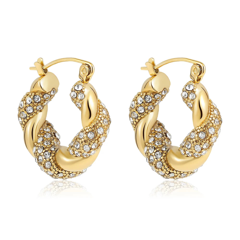 Gold hoop earrings with embedded crystals on a white background