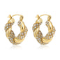 Gold hoop earrings with embedded crystals on a white background