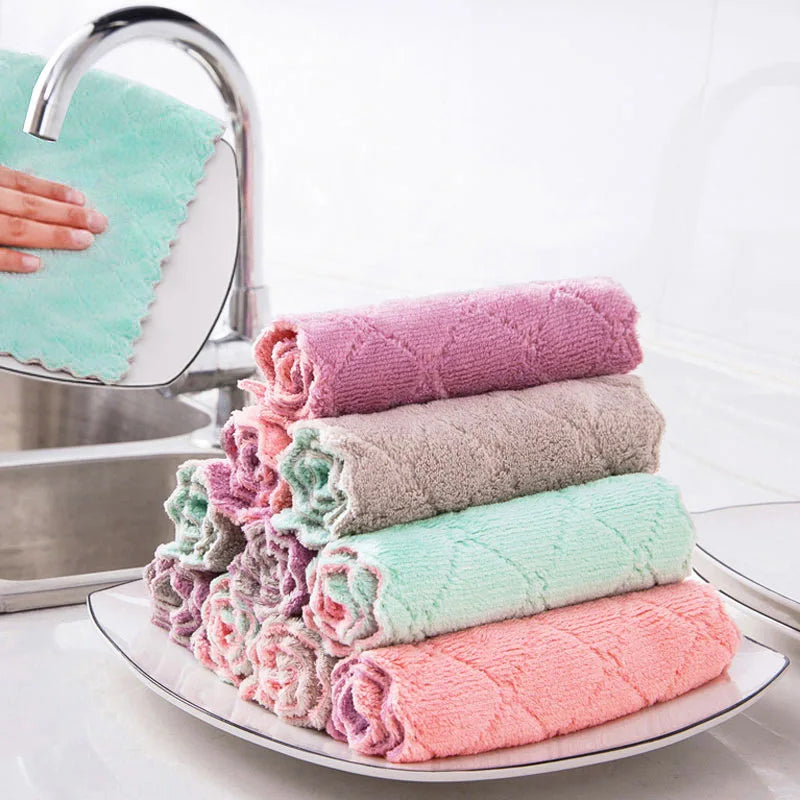 Stack of colorful kitchen towels on a plate with a sink in the background