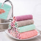 Stack of colorful kitchen towels on a plate with a sink in the background
