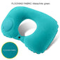 Turquoise inflatable neck pillow with malachite green flocking fabric on a white background.
