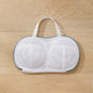 White mesh bag with handles on a wooden surface