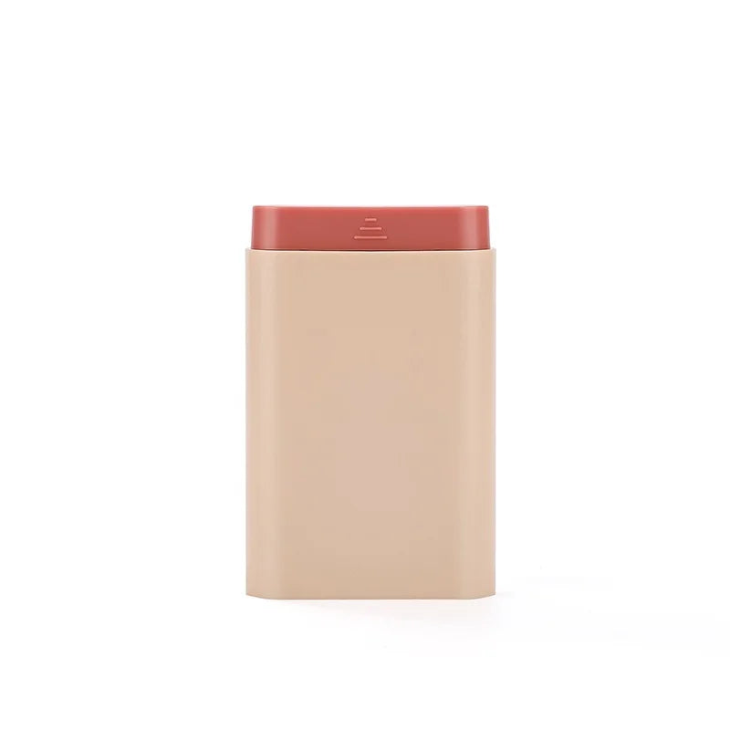 Rectangular beige device with a red top on a white background