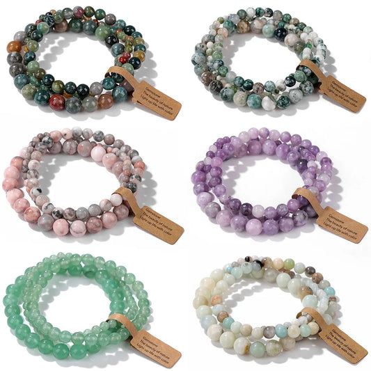 Set of six beaded bracelets in various colors with wooden tags on a white background