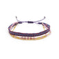 Multistrand bracelet with pink beads and gold accents on a white background