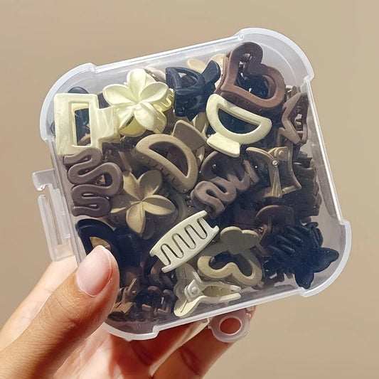 Clear container with decorative hair clips held by a hand against a beige background