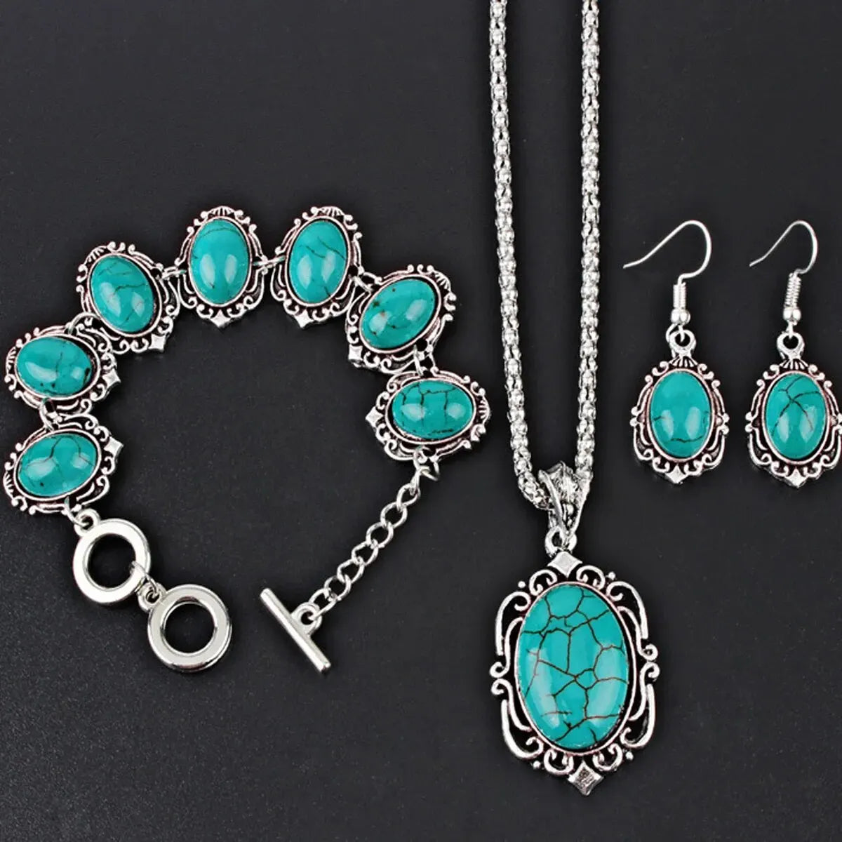 Jewelry set with turquoise stones and silver accents on a black background