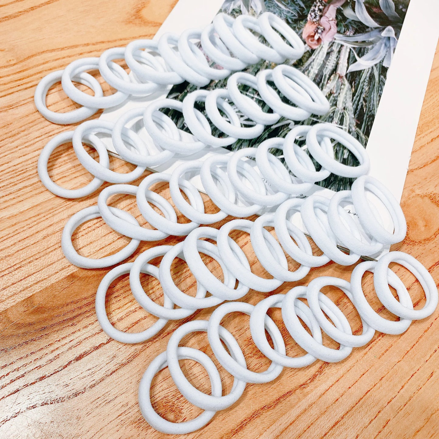 White hair ties on a wooden surface