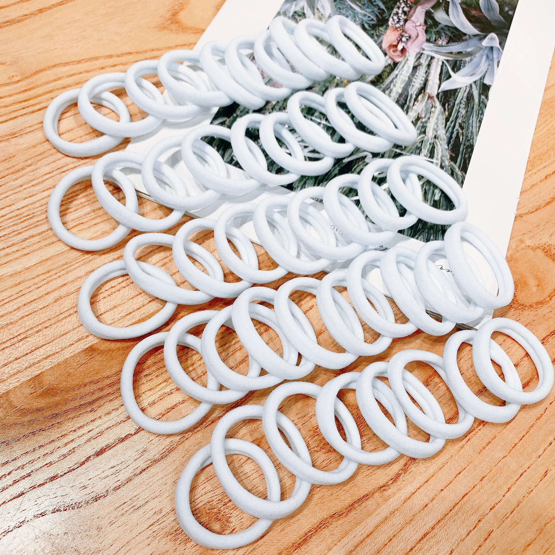 White hair ties on a wooden surface